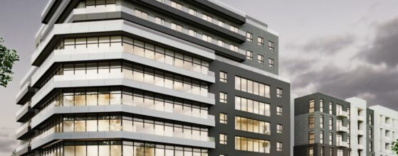 A modern multi-story office and apartment building with large windows at dusk, featuring the address "2 Upton Road" on the front.