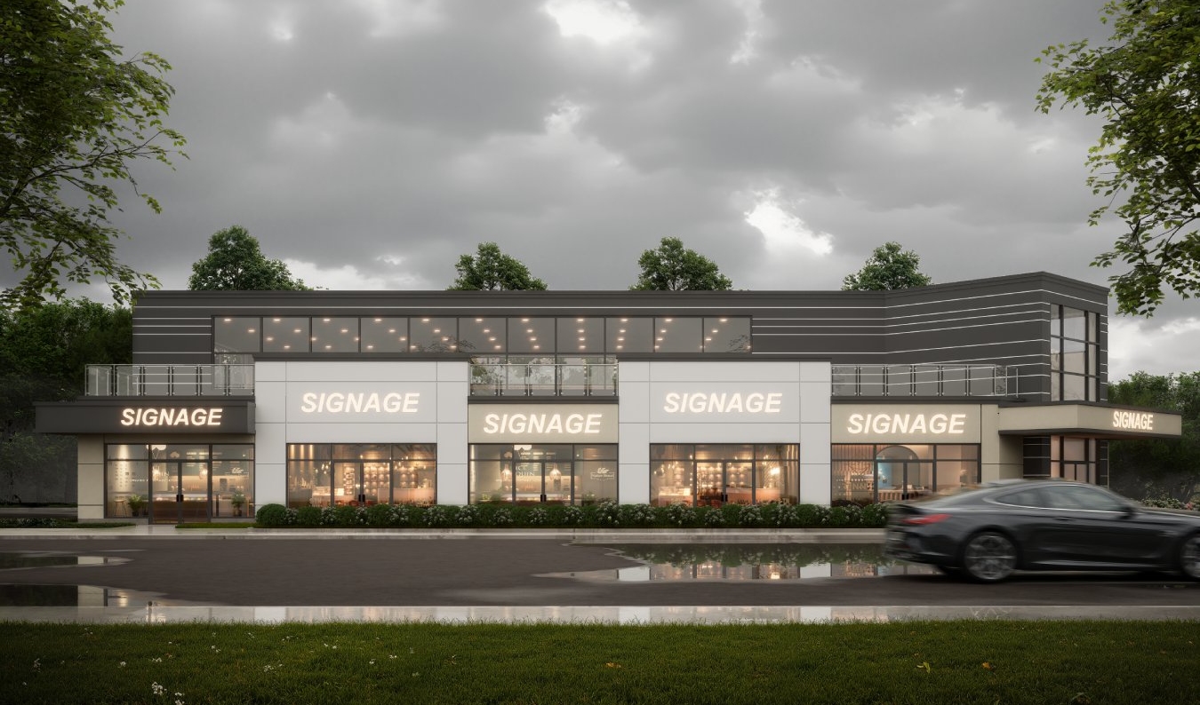 Two-story commercial building with multiple “SIGNAGE” signs, large glass windows, and a dark car driving past on a cloudy day at 2008 Port Robinson Road. Trees and greenery are in the background.
