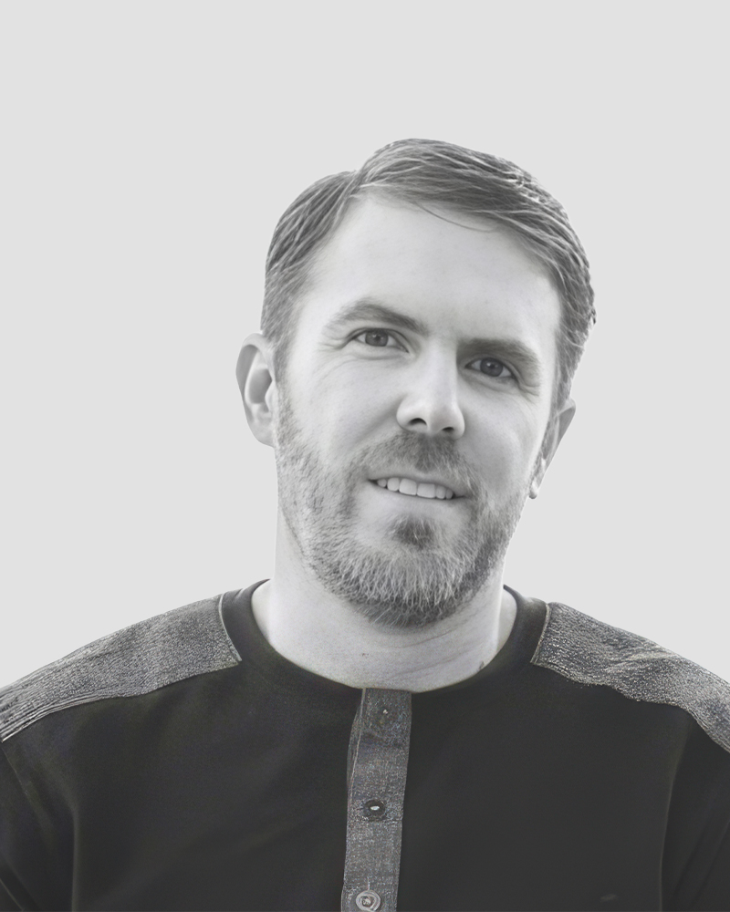 Black and white portrait of a man with a beard looking at the camera.