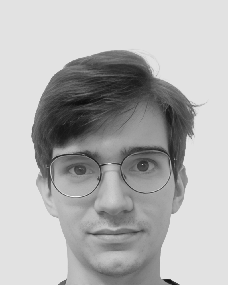 Headshot of a young man wearing round glasses.